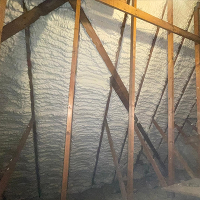 inside view of the roof rafters with spray foam insulation applied first angle